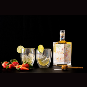 MAD Craft Spiced Rum Strawberry & Honey featuring Art by John Goldsworthy © Modern Art Distillery 2023 Series 1 'Connections' and two glasses of Rum